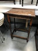 A 1930's oak side table with barley twist legs