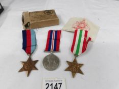 A set of 3 WW2 medals (Italy Star, 1939-45 Star and War medal) with original O.H.M.