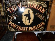 A painted sign "Victorian Portrait Parlour".