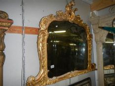 An early 19th century giltwood over mantel mirror, approximately 92 x 115 cm.