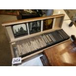 A wooden box containing approximately 100 black and white lantern slides,