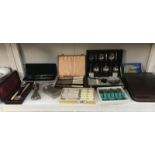 A mixed lot including cased cutlery, cased travelling wash set,
