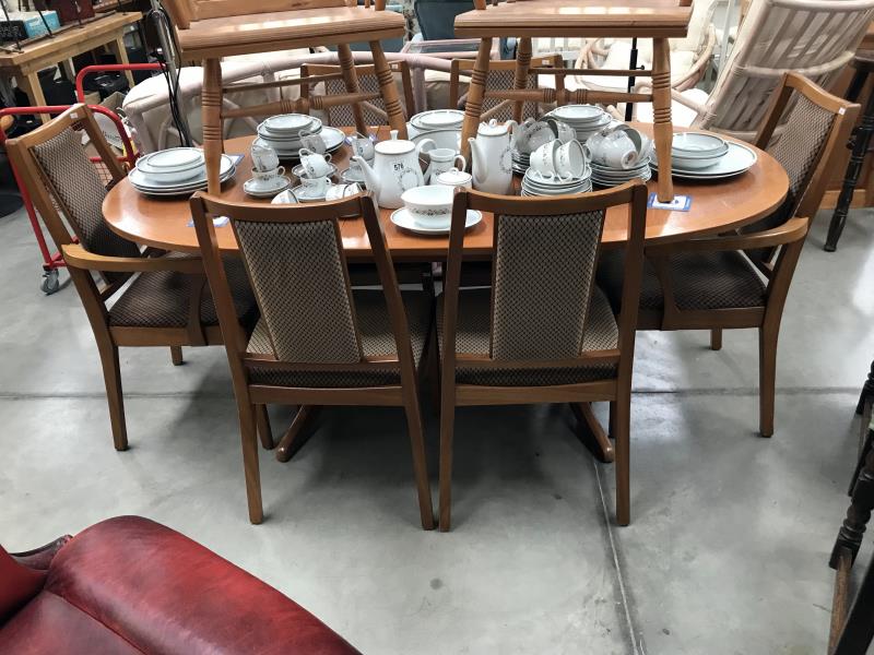 A teak extending dining table and 6 chairs