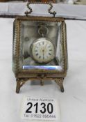 A continental gilt and glass watch case with a Victorian ladies silver fob watch.