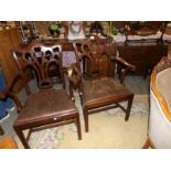 A pair of mahogany elbow chairs.