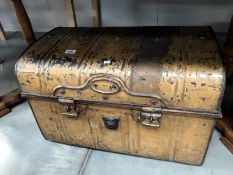 A dome top tin trunk