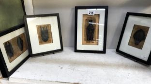 A set of 4 framed and glazed miniature African masks/figure