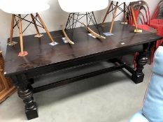 A dark oak refrectory table with heavy turned legs