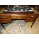 An oak desk with leather top.