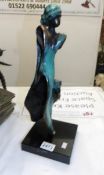 A contemporary bronze statue, signed but indistinct.