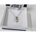 A diamond pendant set with 4 diamonds in 14ct white gold on attached neck chain.