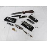 9 various pocket knives including camping and multi tool knives together with a hunting knife.