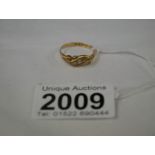 An 18ct gold ring set 5 diamonds, size O.