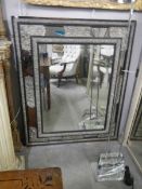 A 19th century French ebony mirror with gilt repousse' silver., approximately 125 x 109 cm.