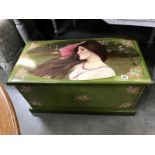 A painted blanket box featuring a lady and flowers
