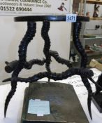 An old stool with base made from horns.
