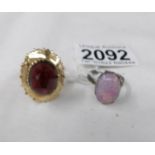 An unmarked yellow metal ring set red stone, size O and a silver ring, size P.