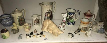 A quantity of old jugs and cat ornaments