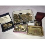 A box of yellow metal costume jewellery, cuff links, tie clips etc.