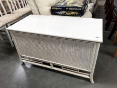 A painted blanket box with bergere panels