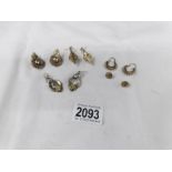 4 pairs of unmarked yellow metal earrings and a pair of white metal earrings.