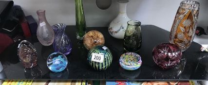 11 assorted items of coloured glassware including vases, paperweights etc.