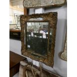 A distressed 17th century mirror. 50 x 58 cm.