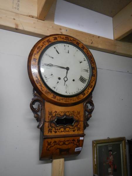 An inlaid drop dial wall clock.