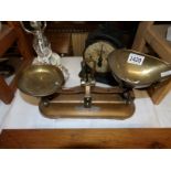 A set of old kitchen scales with brass pans.