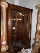 A mahogany glazed corner cabinet.