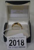 An 18ct gold ring set A sapphire and 2 diamonds, size S.