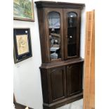 A Victorian mahogany glazed top corner cabinet