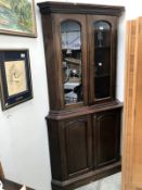 A Victorian mahogany glazed top corner cabinet