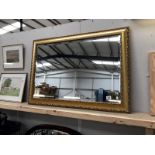 A framed bevel edge mirror