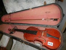 An old cased violin with bow.