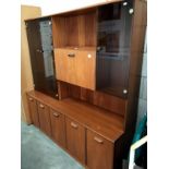 A teak wall unit with smoke glass doors