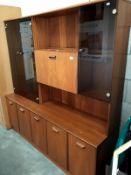 A teak wall unit with smoke glass doors