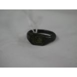 an antiquarian bronze ring with 'W' initial under a crown, size R.