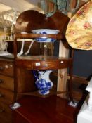 A Victorian mahogany corner washstand with modern blue and white jug and basin set.