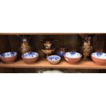 A quantity of lustre ware jugs and blue and white terracotta dishes
