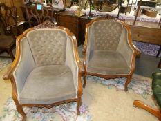 A pair of mahogany framed salon chairs.
