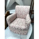 A pink floral fabric nursing arm chair