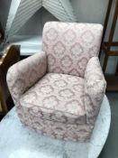 A pink floral fabric nursing arm chair