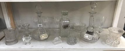 3 glass decanters with labels and glassware