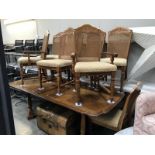A French style extending dining table and 8 chairs with fabric seats and bergere backs