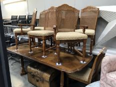 A French style extending dining table and 8 chairs with fabric seats and bergere backs