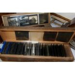 Two wooden boxes containing approximately 100 glass lantern slides taken around early 20th century
