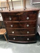 A Victorian mahogany veneered bow front chest of drawers with glass shelves