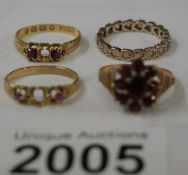 A 9ct gold ring set garnets, an 18ct gold ring with central stone missing,