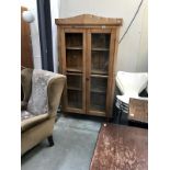 A pine cupboard with glazed doors - 1 glass panel missing